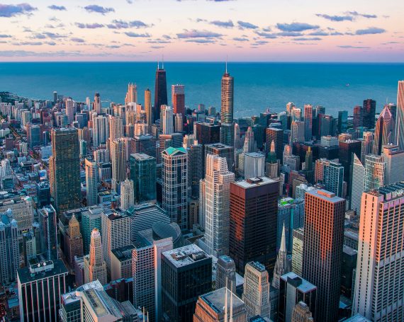 Drone shot of Chicago, IL at sunset overlooking Lake Michigan